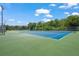 Two well-maintained tennis courts with blue surface and green surrounding at 2343 Prospect St, Sarasota, FL 34239