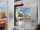 Private balcony with white louvered doors, offering an outdoor view at 4241 Gulf Of Mexico Dr # 202, Longboat Key, FL 34228