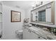 Clean bathroom with granite countertop and a large mirror at 4241 Gulf Of Mexico Dr # 202, Longboat Key, FL 34228