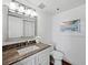 Updated bathroom with granite countertop and white vanity at 4241 Gulf Of Mexico Dr # 202, Longboat Key, FL 34228