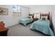 Guest bedroom with two twin beds and wood nightstands at 4241 Gulf Of Mexico Dr # 202, Longboat Key, FL 34228