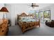 Bright bedroom with wood bed frame and access to a balcony at 4241 Gulf Of Mexico Dr # 202, Longboat Key, FL 34228
