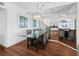 Bright dining room with glass table and wicker chairs at 4241 Gulf Of Mexico Dr # 202, Longboat Key, FL 34228