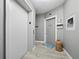 Bright condo entryway with elevator access and beach decor at 4241 Gulf Of Mexico Dr # 202, Longboat Key, FL 34228