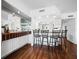 Kitchen bar with three stools and tile backsplash at 4241 Gulf Of Mexico Dr # 202, Longboat Key, FL 34228