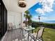 Relaxing balcony with ocean view, seating, and ceiling fan at 4241 Gulf Of Mexico Dr # 202, Longboat Key, FL 34228
