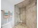 Large walk-in shower with stone tile floor at 4241 Gulf Of Mexico Dr # 202, Longboat Key, FL 34228