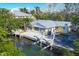 Aerial view of waterfront home with private dock and boat lifts at 563 Juan Anasco Dr, Longboat Key, FL 34228