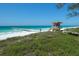 Beachfront property with lifeguard stand and pier at 563 Juan Anasco Dr, Longboat Key, FL 34228