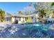 Spacious patio with a teal table and chairs, overlooking the pool at 563 Juan Anasco Dr, Longboat Key, FL 34228