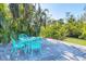 Small patio with teal table and chairs at 563 Juan Anasco Dr, Longboat Key, FL 34228