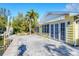 Waterfront view of a yellow house with patio and private dock at 563 Juan Anasco Dr, Longboat Key, FL 34228