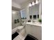 Clean bathroom with white vanity, a large mirror and shower/tub combo at 601 N Hercules Ave # 1403, Clearwater, FL 33765