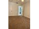 Spacious bedroom with neutral carpeting and an open door to hallway at 601 N Hercules Ave # 1403, Clearwater, FL 33765