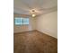 Bedroom with neutral carpeting, a window with blinds and ceiling fan at 601 N Hercules Ave # 1403, Clearwater, FL 33765