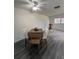Dining area features wood table and chairs, gray flooring and ceiling fan at 601 N Hercules Ave # 1403, Clearwater, FL 33765