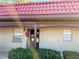 Exterior view of condo with red tile roof and landscaping at 601 N Hercules Ave # 1403, Clearwater, FL 33765