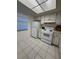 Kitchen with white cabinets, appliances and tile flooring at 601 N Hercules Ave # 1403, Clearwater, FL 33765
