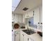 Kitchen features white cabinets, double sink and a pass-through window at 601 N Hercules Ave # 1403, Clearwater, FL 33765
