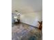 Living room with gray patterned rug and a large, neutral colored wall at 601 N Hercules Ave # 1403, Clearwater, FL 33765