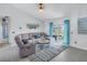 Relaxing living room featuring a sectional sofa and access to a patio at 6025 62Nd E Ct, Palmetto, FL 34221