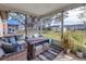 Relaxing screened porch with wicker furniture and backyard view at 6025 62Nd E Ct, Palmetto, FL 34221