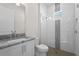 Modern bathroom with a large walk-in shower and granite countertop at 8328 Sea Glass Ct, Sarasota, FL 34240