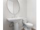 Stylish powder room with pedestal sink and toilet at 8328 Sea Glass Ct, Sarasota, FL 34240