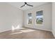 Bright bedroom with wood-look floors and two large windows at 8328 Sea Glass Ct, Sarasota, FL 34240