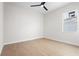 Bright bedroom with wood-look floors and ceiling fan at 8328 Sea Glass Ct, Sarasota, FL 34240