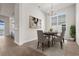 Bright dining room featuring a large window and modern chandelier at 8328 Sea Glass Ct, Sarasota, FL 34240