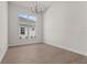 Bright dining room with large window and chandelier at 8328 Sea Glass Ct, Sarasota, FL 34240
