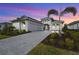 Beautiful home exterior at sunset with 3-car garage at 8328 Sea Glass Ct, Sarasota, FL 34240