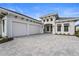 Two-story home with three-car garage and paver driveway at 8328 Sea Glass Ct, Sarasota, FL 34240