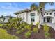 Luxury home exterior with landscaping and a 3-car garage at 8328 Sea Glass Ct, Sarasota, FL 34240