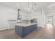 Modern kitchen with a large island, stainless steel appliances, and white cabinets at 8328 Sea Glass Ct, Sarasota, FL 34240