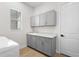 Well-appointed laundry room with gray cabinets and quartz countertops at 8328 Sea Glass Ct, Sarasota, FL 34240