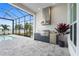 Modern outdoor kitchen with built-in grill and lake view at 8328 Sea Glass Ct, Sarasota, FL 34240