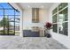 Modern outdoor kitchen, stainless steel appliances, gray cabinets at 8328 Sea Glass Ct, Sarasota, FL 34240