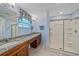 Bathroom with double vanity, granite countertop, and large shower at 8755 Dolomite Ave, North Port, FL 34287