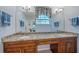 Bathroom with double vanity, granite countertop, and large mirror at 8755 Dolomite Ave, North Port, FL 34287
