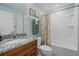 Clean bathroom with granite countertop and floral shower curtain at 8755 Dolomite Ave, North Port, FL 34287