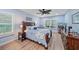 Bedroom with wooden furniture, blue bedding and window shutters at 8755 Dolomite Ave, North Port, FL 34287