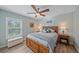 Bright bedroom with wood bed frame and plantation shutters at 8755 Dolomite Ave, North Port, FL 34287