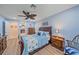 Light blue bedroom with wooden furniture, blue bedding, and ensuite bathroom at 8755 Dolomite Ave, North Port, FL 34287