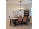 Dining room with dark wood table, chandelier, and neutral decor at 8755 Dolomite Ave, North Port, FL 34287