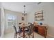 Bright dining area features round table and chairs with window seating at 8755 Dolomite Ave, North Port, FL 34287