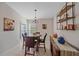 Casual dining area with round table and chairs and built-in shelving at 8755 Dolomite Ave, North Port, FL 34287