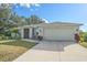 Front view of single-story house with light-grey exterior and two-car garage at 8755 Dolomite Ave, North Port, FL 34287