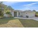 Single-story home with light grey exterior, two-car garage, and landscaped lawn at 8755 Dolomite Ave, North Port, FL 34287